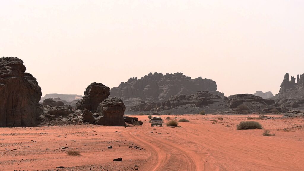 Tin Merzouga red dunes and black mountains in Tassili n’Ajjer